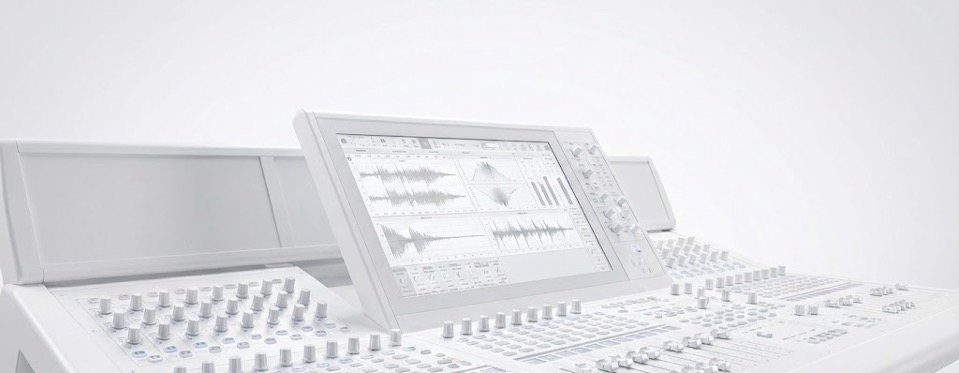 White digital audio mixing console with acoustic analysis visible on its central display